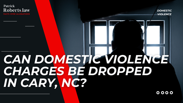 Silhouette of a man looking out a window from a dimly lit room, illustrating the question “Can domestic violence charges be dropped in Cary, NC?” with Patrick Roberts Law branding.