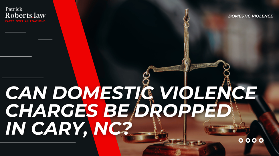 Scales and gavel on desk with firm branding; headline asks if Cary, NC domestic violence charges can be dropped.